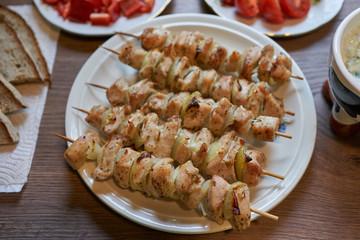 Close up Picture on the light and healthy dish, full of nutritions, charcoal grilled skewers consist from marinated chicken breast pieces and chopped onion on the bamboo stick. Food suitable for diet.