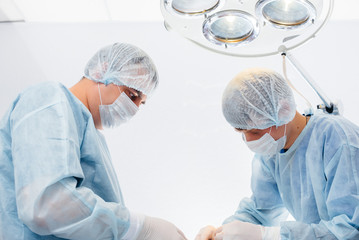 Operation in a modern operating room close-up, emergency rescue and resuscitation of the patient. Medicine and surgery