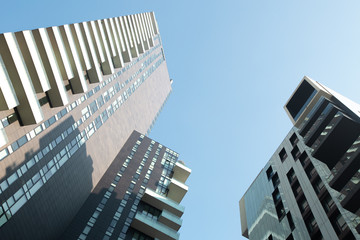 Fototapeta na wymiar Two huge modern residential buildings against the blue sky. 01.20 Milan.