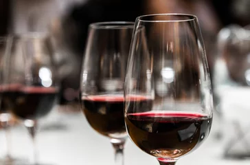 Fotobehang Close up of wine glasses with red wine in the tasting room © Aleksandr Vorobev