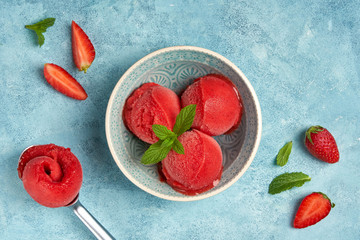 Homemade strawberry ice cream , sorbet in bowl with mint leaves. Top view
