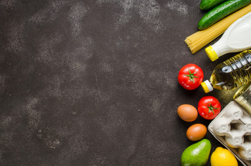 Various groceries on dark concrete background. Food delivery concept. Food donations.