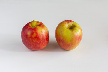 couple of apples on a white background. vitamin duo