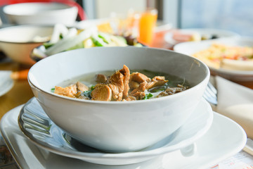 Meat soup in white bowl on table