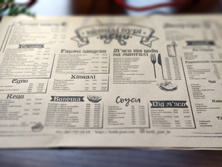 Newspaper, restaurant menu, printed products on wooden table