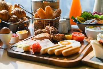 Wooden board with meat, sausages for breakfast