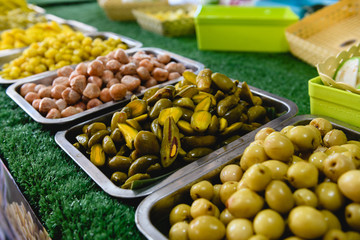 Pickled Thailand preserved fruits - marian plum, apples at street food market counter for sell close up