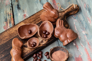 dark chocolate of different shapes on rustic wood to eat at special parties