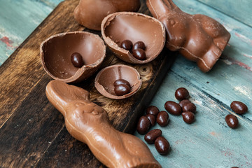 dark chocolate of different shapes on rustic wood to eat at special parties