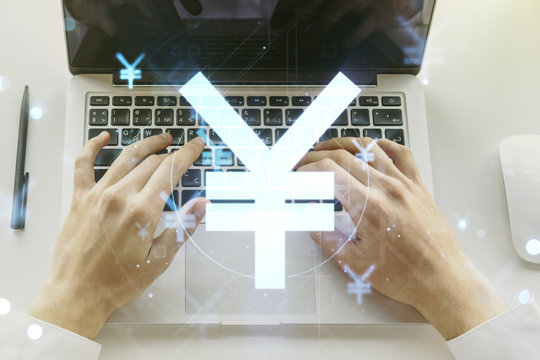 Creative Japanese Yen symbol sketch and hands typing on computer keyboard on background, strategy and forecast concept. Multiexposure