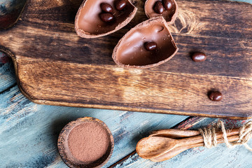 dark chocolate of different shapes on rustic wood to eat at special parties