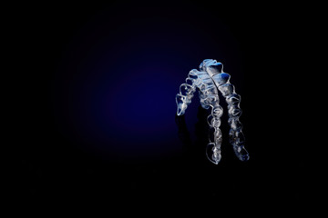 Invisible orthodontics cosmetic brackets on blue gradient background, tooth aligners, plastic...