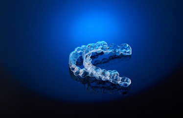 Invisible orthodontics cosmetic brackets on blue gradient background, tooth aligners, plastic...