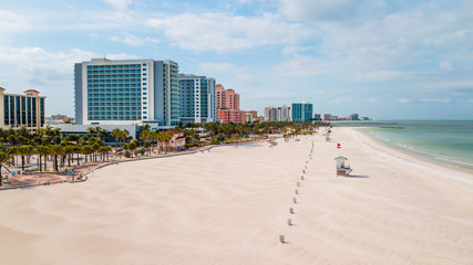 Beach closed or opened in Florida Warning of coronavirus or covid-19.  Palm Trees on the beach. Locations Clearwater Beach FL. Coast or shore Gulf of Mexico. Spring or Summer vacation. Closed hotel.