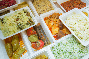 Delivery sets of healthy and delicious food in boxes . A variety of fast food in plastic boxes .