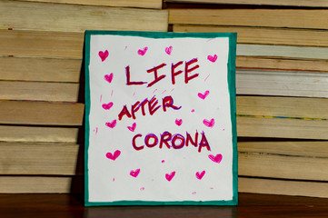 Life after covid-19 coronavirus poster on the stack of books