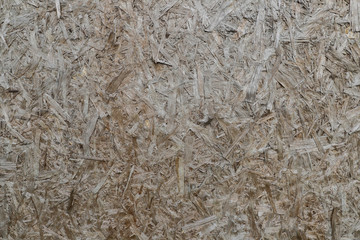 natural background from chipboard, glued chips of wood the natural color , texture of sawdust