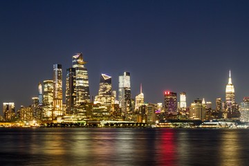 Beautiful view of New York city skyline with waterfront at night, USA