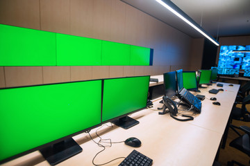 Empty office, desk, and chairs at a main CCTV security data center.