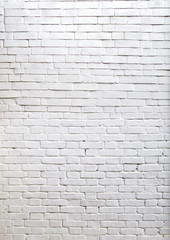 Three- dimensional elements of brickwork on the wall. Terraces on an old brick wall. Old weathered white brick.