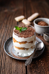 Classic Italian coffee no bake dessert, delicious easy Tiramisu in a jar, sprinkled with cocoa powder and chocolate shavings
