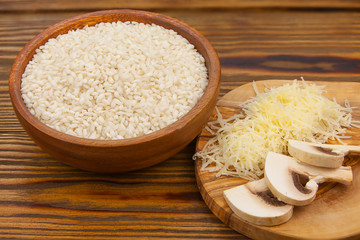 Tasty appetizing risotto on  white plate on  wooden table