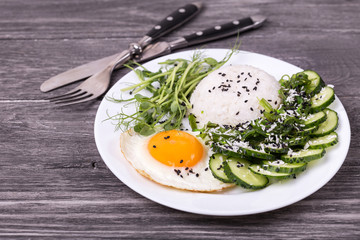 Rice with cucumber, scrambled eggs, microgreen and Japanese wakame seaweed salad.