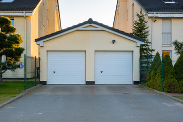 Two garages with white doors in contemporary estate
