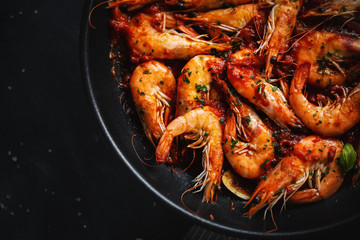 Fried shrimps with spices on pan