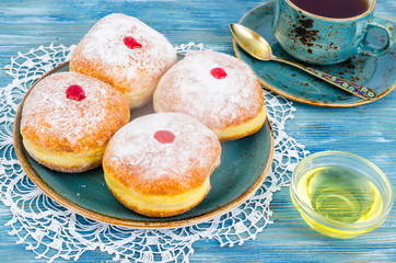 Traditional food doughnuts with icing sugar and jam. Concept and background Jewish holiday Hanukkah.