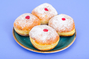 Obraz na płótnie Canvas Traditional food doughnuts with icing sugar and jam. Concept and background Jewish holiday Hanukkah.