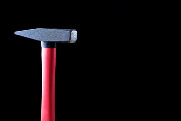 top of the hammer for the nails on a black background. high quality, beautiful color, high definition. space for text and ads. copy paste and copyright