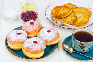 Concept and background Jewish holiday Hanukkah. Traditional food doughnuts and potatoes pancakes latkes. Flat lay or top view.