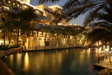 DUBAI, UAE -: Night view of Madinat Jumeirah hotel, Dubai, UAE. Madinat Jumeirah - luxury 5 star hotel with own artificial canals and boats.