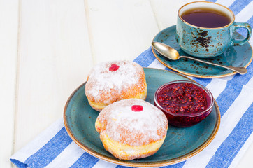 Traditional food doughnuts with icing sugar and jam. Concept and background Jewish holiday Hanukkah.