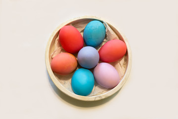 Fototapeta na wymiar Easter eggs in different colors in ceramic dish