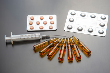 medical ampoules for injection, tablets and syringe. medicines and disease treatment. pharmacology and science