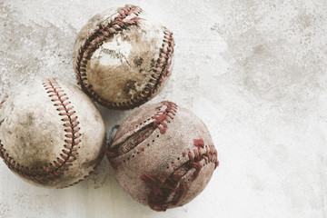 Fototapeta na wymiar Old game balls close up with grunge texture, baseball sport background with copy space.