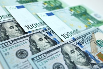 Background of money dollars and euros in a pattern, close up of 100 banknotes of leading currency 