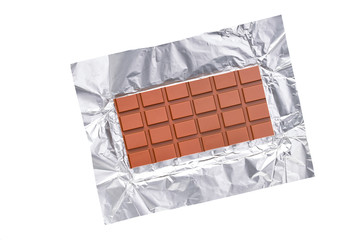 open packaging of milk chocolate isolated on white background top view.