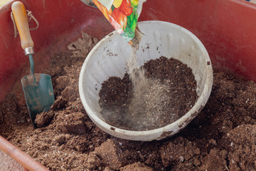 Mixing Soil and Fertilizer in Wheelbarrow for Gardening