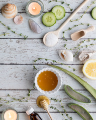 Top down view of various natural remedies in a border arrangement, used for beauty and wellness therapy treatments.