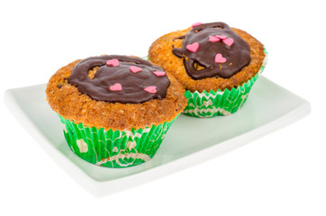 Homemade cakes. Two delicious vanilla sweet muffins with chocolate icing.