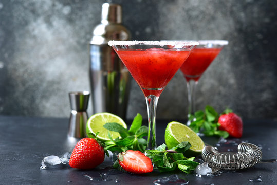 Cold summer strawberry cocktail with lime and mint ( mojito, margarita, rossini,daiquiri ) in a martini glasses.