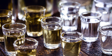 Obraz na płótnie Canvas glasses of alcoholic drink, small dose. Rum, vodka, vermouth, cachaça, gin and liquor.