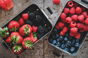 Healthy summer vegan lunch. Flat-lay of fresh seasonal strawberries, raspberries, blueberries and...