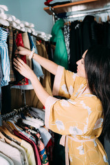 Fototapeta na wymiar woman choosing clothes in the closet
