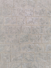 gray concrete wall lined on tiles for background and texture