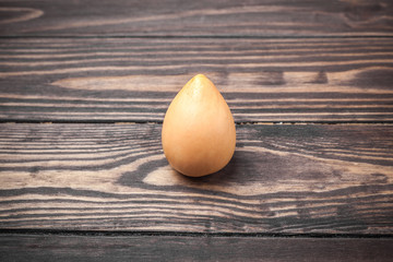 Bone from avocado. close-up on a wooden background from boards.