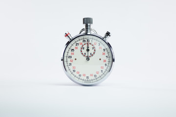 Analogic vintage chronometer clock with red and black numbers on white background